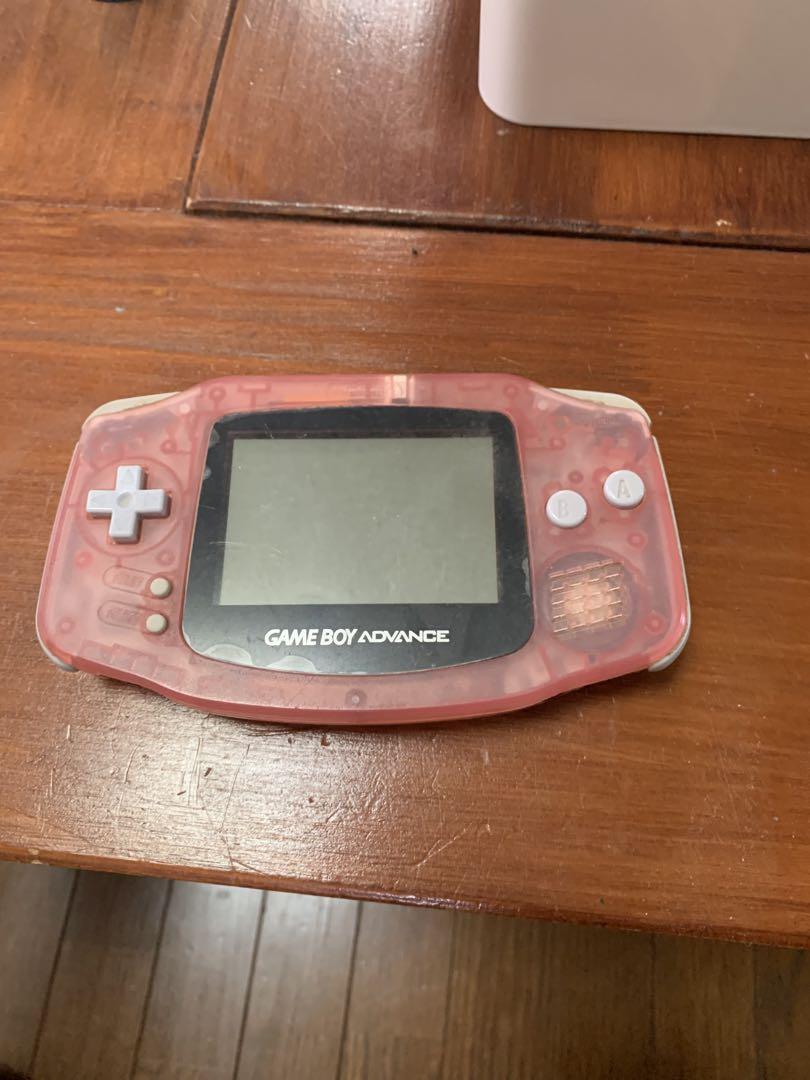 The photo shows an image of the Game Boy Advance main unit with the AC adapter attached.